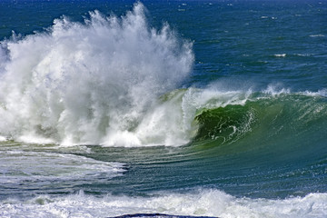 Fototapeta premium Big, dangerous waves during tropical storm in the green and blue waters of Rio de Janeiro, Brazil