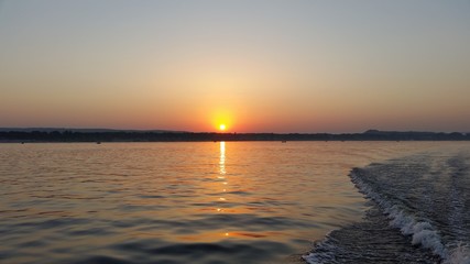 Dawn on the boat while driving the spray from the motor