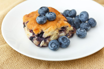 Blueberry scone on white plate