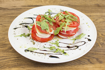 Fresh sandwiches with tomatoes, lettuce, cheese on a white plate.