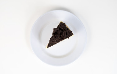 Chocolate cookies oreo cheese cake slice on white dish