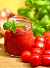 Fototapeta na wymiar Tomato sauce and Italian basil in a glass jar