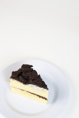 Chocolate cookies oreo cheese cake slice on white dish