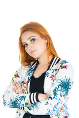 Semi profile of girl with crossed arms. Redheaded girl wearing colorful jacket. Summer..