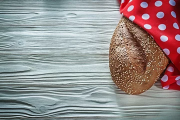 Foto op Plexiglas Loaf of bread polka-dot napkin on vintage wooden board © mihalec