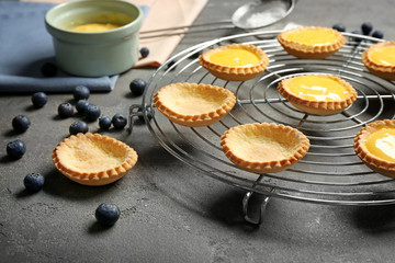 Cooling rack with delicious crispy tarts on table