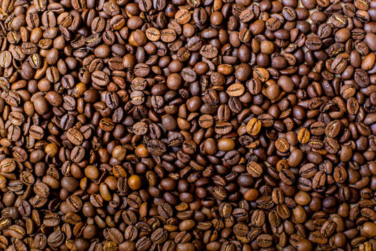 Coffee pattern. Roasted coffee beans background. © lisannart