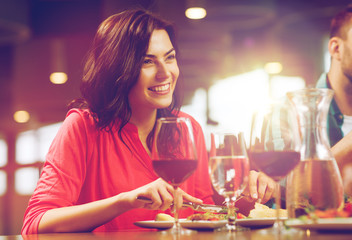 happy woman having dinner at restaurant