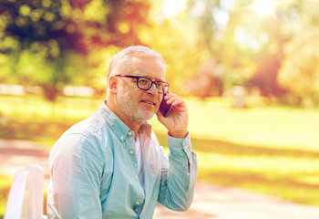 senior man calling on smartphone at summer park