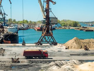 Landscape of tugboats and cranes in shipyard in coast