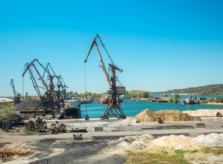 Landscape of tugboats and cranes in shipyard in coast