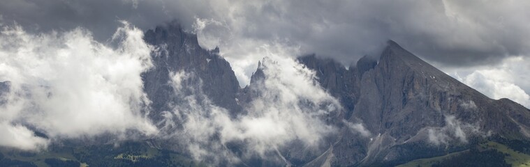 panorama of Dolomite rocks in clouds in Italy