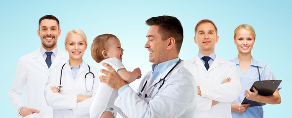 Fototapeta na wymiar happy doctor or pediatrician with baby over blue