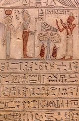 Hieroglyphic carvings on the exterior walls of an ancient egyptian temple