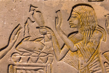 Hieroglyphic carvings on the exterior walls of an ancient egyptian temple