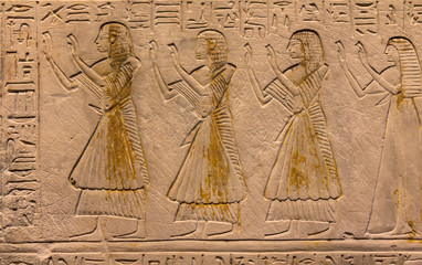 Hieroglyphic carvings on the exterior walls of an ancient egyptian temple