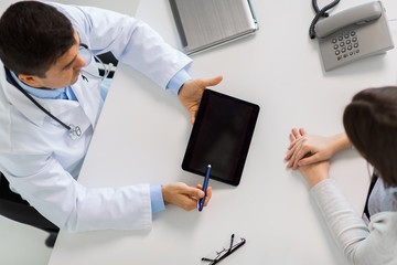 smiling doctor and young woman meeting at hospital