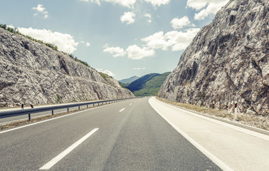 Highway outside the city receding into the highlands.