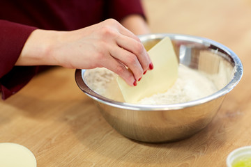 chef with flour in bowl making batter or dough