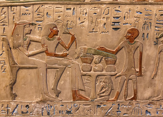 Hieroglyphic carvings on the exterior walls of an ancient egyptian temple