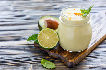 Useful smoothies of avocado in a glass jar.