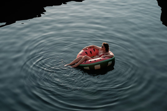 Woman Floating On Inflatable Tube In The Sea