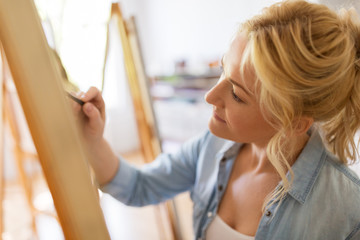 woman artist with pencil drawing at art school