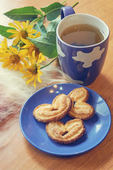 closeup of herbal tea and heart shape cookies