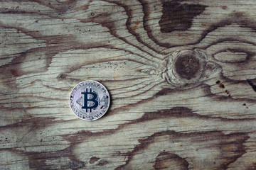 Silver bitcoin on wooden background