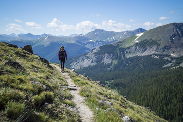 Fototapeta na wymiar Woman Walks in Mountains