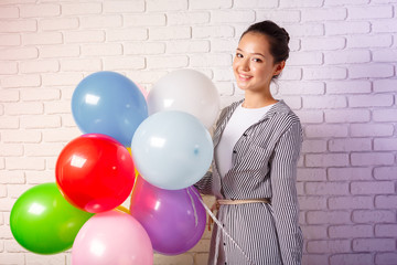 Fototapeta na wymiar Pretty woman with colored balloons