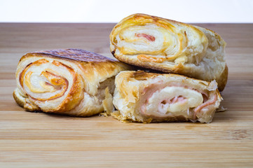 Delicious italian snack with puff pastry on wooden board