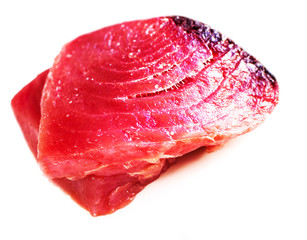 Raw tuna steak isolated on white background close up .