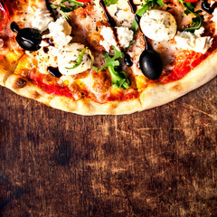 Fresh baked Hot pizza slice with cheese on a rustic wooden table  closeup.