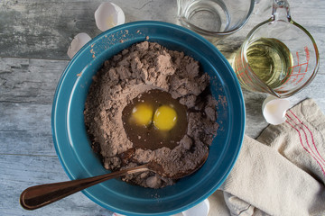 Brownie mix in bowl showing two eggs with ingredients top view