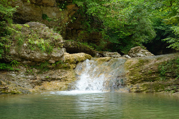 Small waterfall in mountain forest