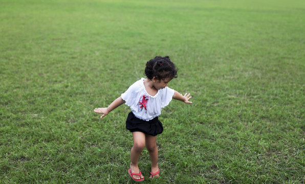 Energetic kid streatching hands and making fun at outdoor