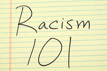 The words "Racism 101" on a yellow legal pad