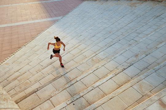Fast runner on steps in sunlight