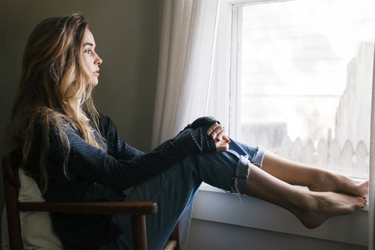 Girl looking out window