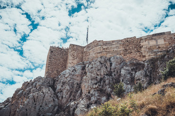 Old stone brick citadel on rocky cliff