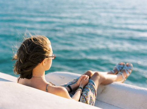 Girl looking at sea from cliffs at Scala dei Turchi, Sicily