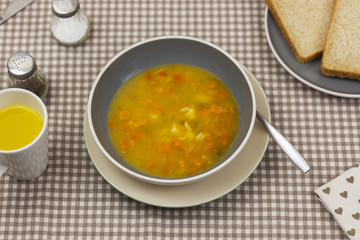 Bowl of fresh homemade vegetable soup on a kitchen table