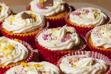 Plate of homemade cupcakes topped in buttercream and sprinkles