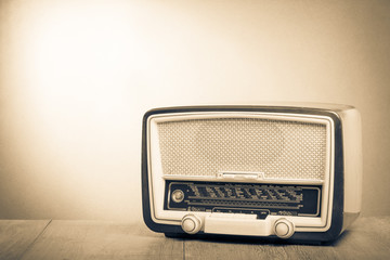 Retro old radio on table. Vintage style sepia photo