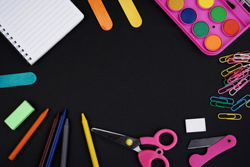Education or Back To School concept. Stationery on a black background view from the top or flat lay.