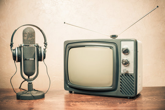 Retro television, headphones and old microphone from 50s. Vintage style filtered photo
