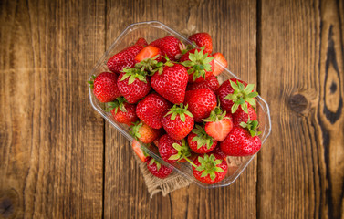 Portion of Strawberries on wooden background, selective focus