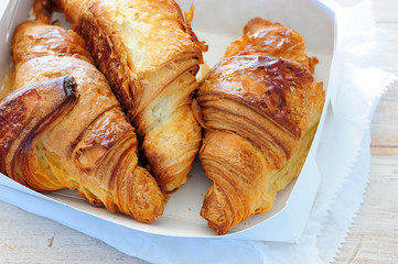 fresh baked croissant on wooden table