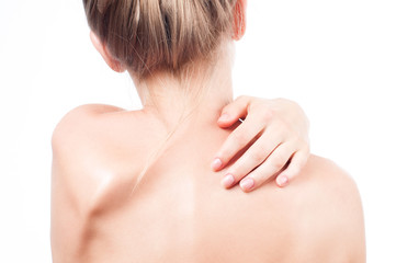 Woman has neck pain. Nude shoulders girl from the back.